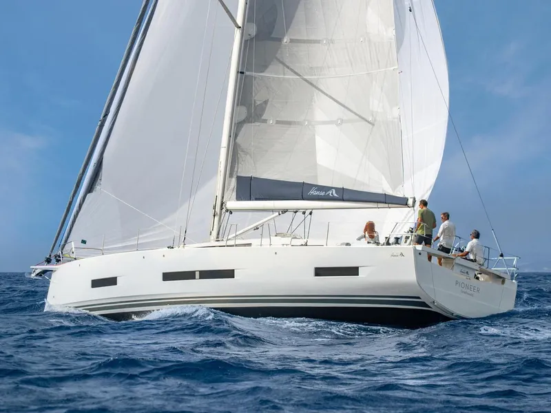 Slide: The Image of 2025 Hanse 510 sailboat navigating ocean waters with crew onboard. - 39