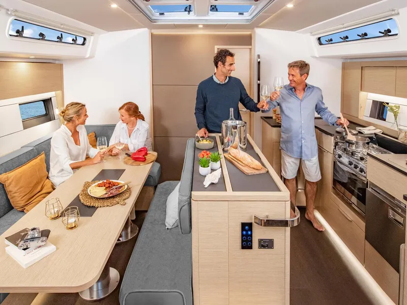 Slide: The Image of People enjoying a meal in the modern interior of a 2025 Hanse 510 yacht. - 9