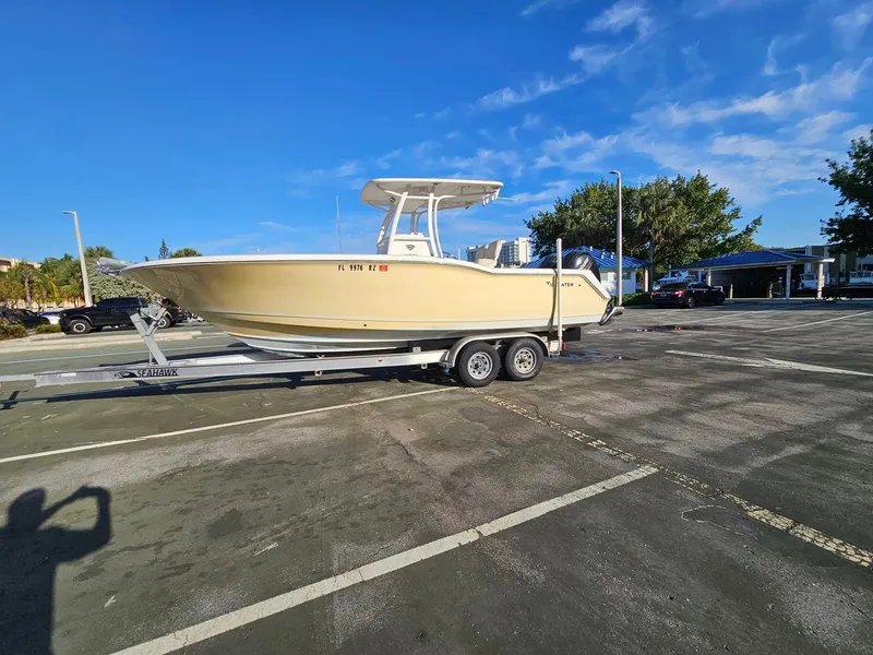 Slide: The Image of 2013 Tidewater 250 CC Adventure boat on trailer in parking lot. - 0