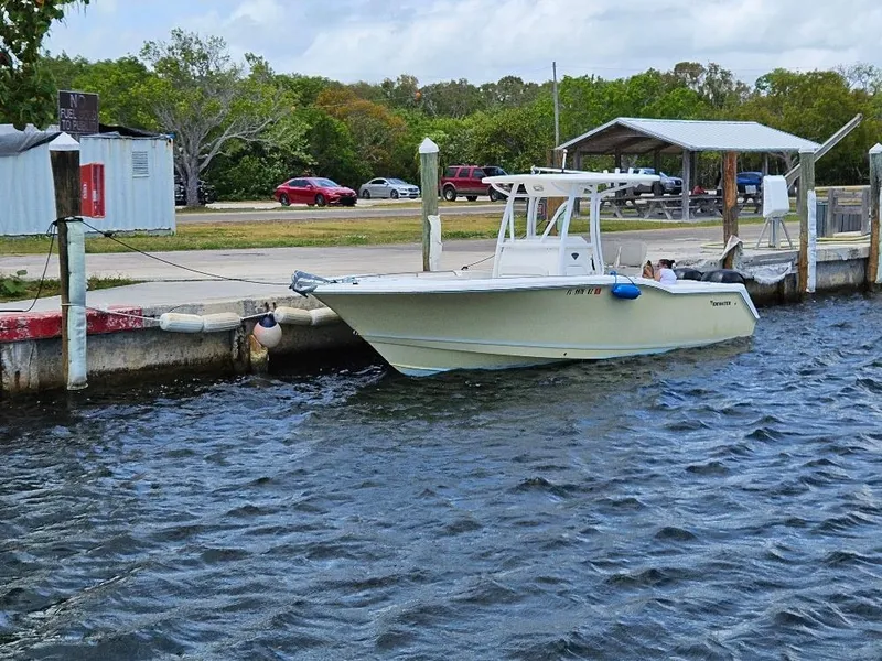Slide: The Image of 2013 Tidewater 250 CC Adventure boat docked by a waterfront. - 1