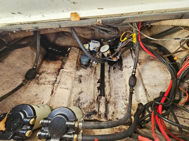 Slide: The Image of 2013 Tidewater 250 CC Adventure boat engine compartment with wiring and fuel filters. - 18