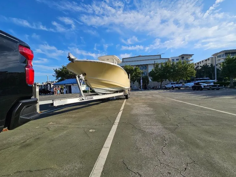 Slide: The Image of 2013 Tidewater 250 CC Adventure boat on trailer in parking lot under blue sky. - 19