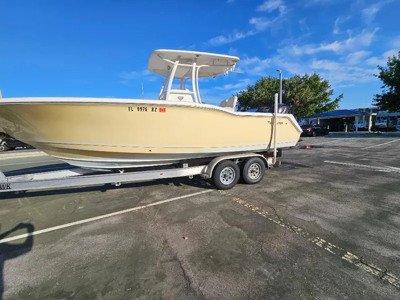 Slide: The Image of 2013 Tidewater 250 CC Adventure boat on trailer in parking lot. - 21