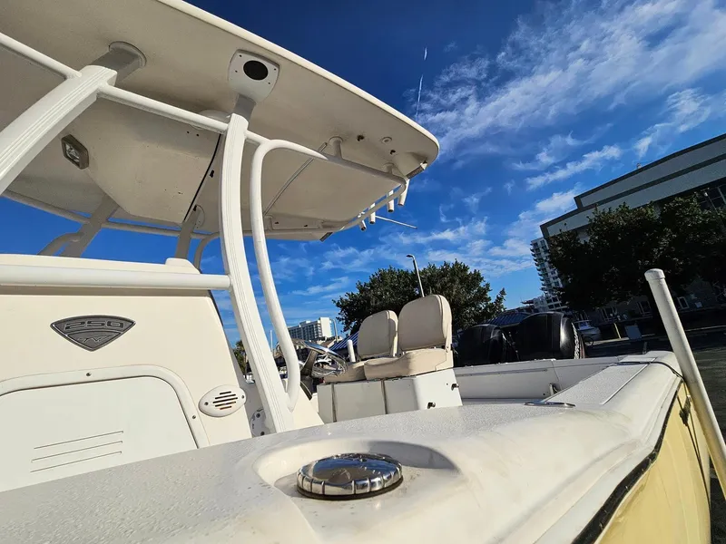 Slide: The Image of 2013 Tidewater 250 CC Adventure boat under clear blue sky. - 24