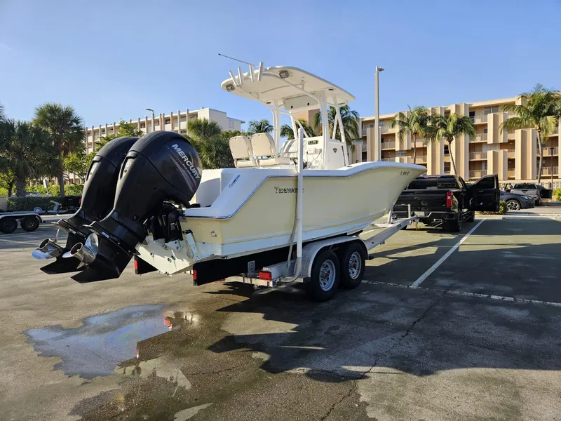 Slide: The Image of 2013 Tidewater 250 CC Adventure boat on trailer in sunny parking lot. - 3