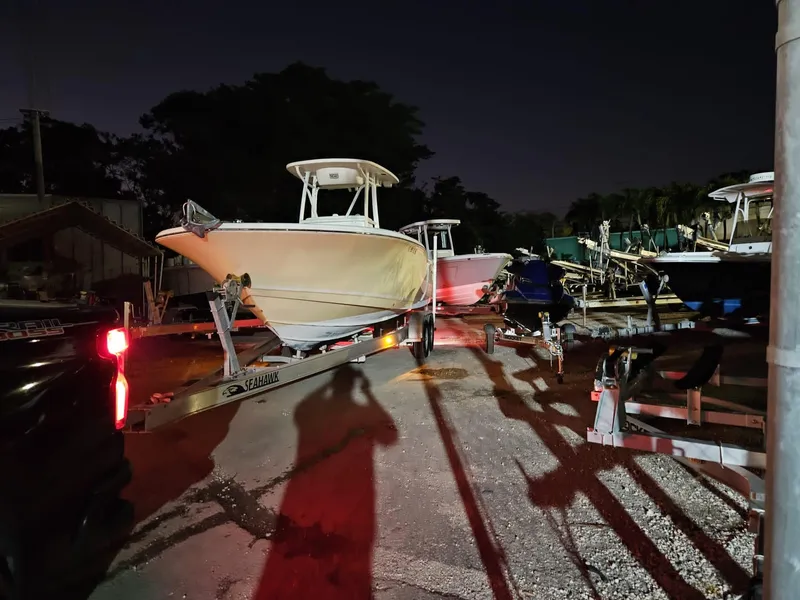Slide: The Image of 2013 Tidewater 250 CC Adventure boat on trailer at night, parked in a lot. - 32
