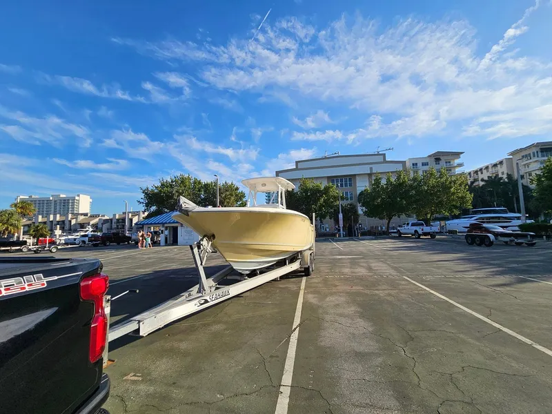 Slide: The Image of 2013 Tidewater 250 CC Adventure boat on trailer in parking lot under blue sky. - 33