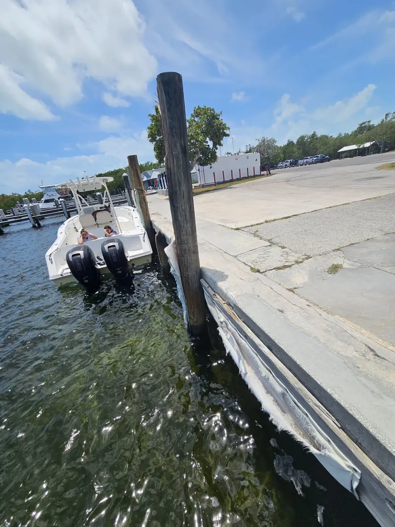 Slide: The Image of Tidewater 250 CC Adventure 2013 boat docked at marina under clear blue sky. - 37
