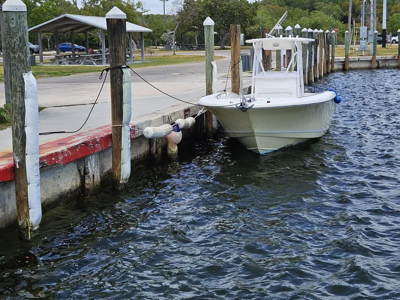 Slide: The Image of 2013 Tidewater 250 CC Adventure boat docked at a marina. - 38