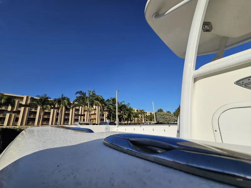 Slide: The Image of 2013 Tidewater 250 CC Adventure boat with clear blue sky and palm trees. - 44