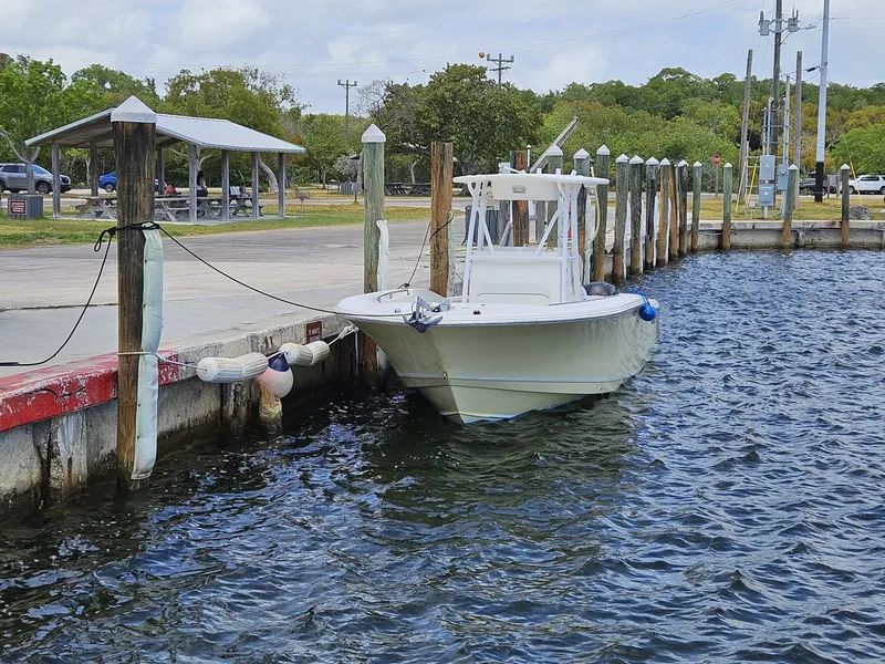 Slide: The Image of 2013 Tidewater 250 CC Adventure boat docked at a marina. - 45