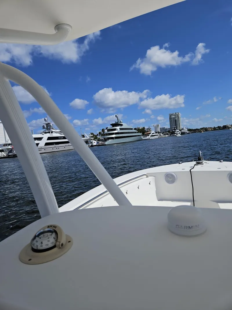 Slide: The Image of View from 2013 Tidewater 250 CC Adventure boat, overlooking marina with yachts and blue sky. - 46