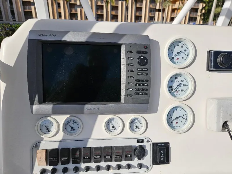 Slide: The Image of Control panel of 2013 Tidewater 250 CC Adventure boat with gauges and Garmin GPS. - 5