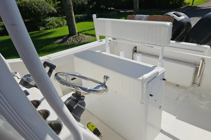 Slide: The Image of 2013 Tidewater 250 CC Adventure boat interior with steering wheel and seating. - 6