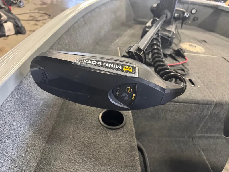 Slide: The Image of 2014 Alumacraft Voyageur 175 Tiller storage compartment with gauges and yellow bag. - 10