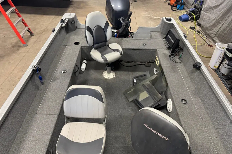 Slide: The Image of 2014 Alumacraft Voyageur 175 Tiller boat interior with seating and equipment. - 17