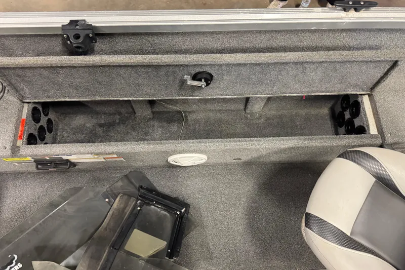 Slide: The Image of 2014 Alumacraft Voyageur 175 Tiller interior storage compartment with seating and rod holders. - 20