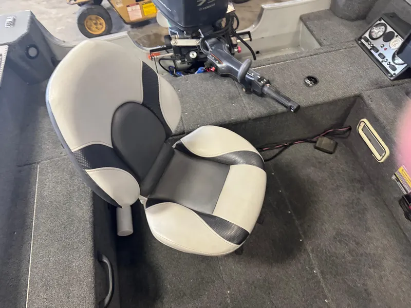 Slide: The Image of 2014 Alumacraft Voyageur 175 Tiller boat interior with motor and control panel. - 7