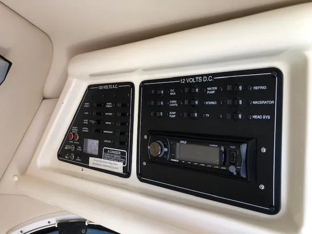 Slide: The Image of Control panel of a 2007 Monterey 250 Cruiser boat, featuring various switches and a stereo system. - 17