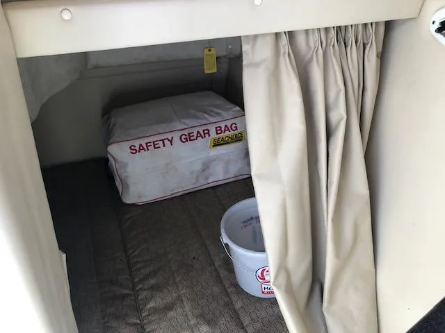 Slide: The Image of 2007 Monterey 250 Cruiser cabin with safety gear bag and bucket. - 18