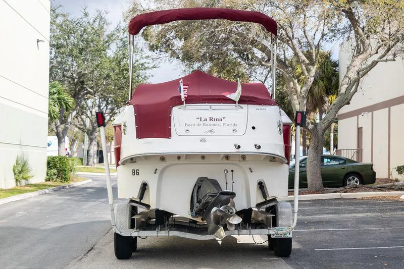 Slide: The Image of 2007 Monterey 250 Cruiser boat with red canopy in parking lot. - 3
