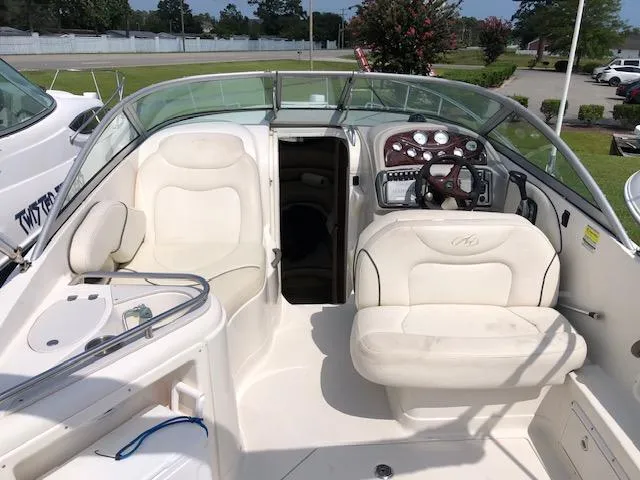 Slide: The Image of 2007 Monterey 250 Cruiser boat interior with white seating and control panel. - 4