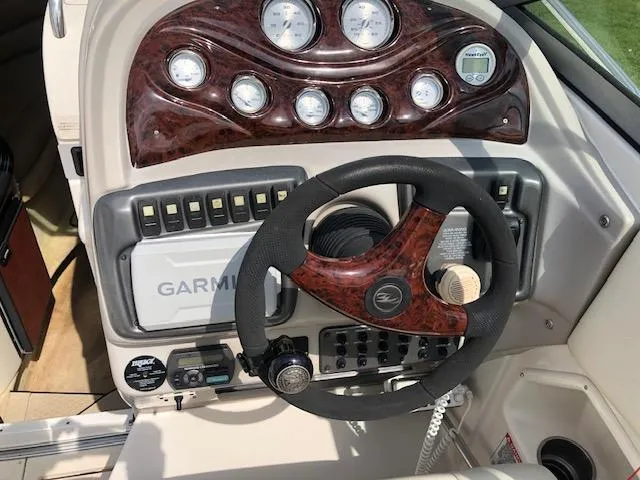 Slide: The Image of 2007 Monterey 250 Cruiser dashboard with Garmin navigation and wood-accented steering wheel. - 9