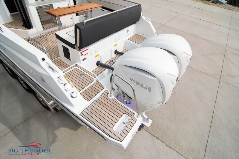 Slide: The Image of 2024 Jeanneau Leader 9.0 WA with twin Yamaha outboard engines on teak deck. - 10