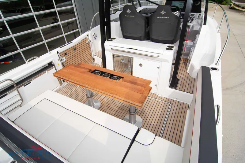 Slide: The Image of 2024 Jeanneau Leader 9.0 WA boat interior with seating and wooden table. - 14
