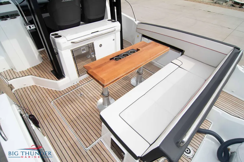 Slide: The Image of 2024 Jeanneau Leader 9.0 WA boat interior with seating and wooden table. - 15