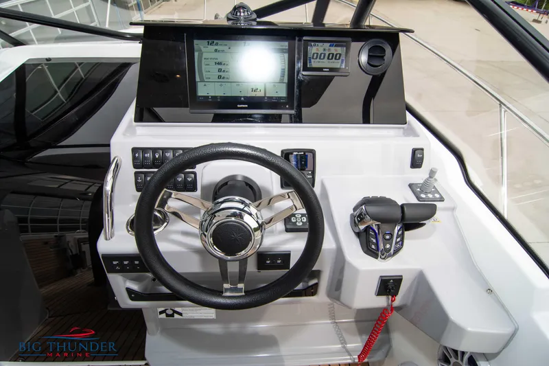 Slide: The Image of 2024 Jeanneau Leader 9.0 WA helm with modern controls and navigation display. - 27