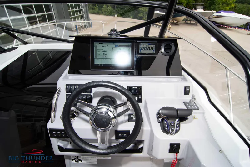 Slide: The Image of 2024 Jeanneau Leader 9.0 WA boat dashboard with steering wheel and control panel. - 29