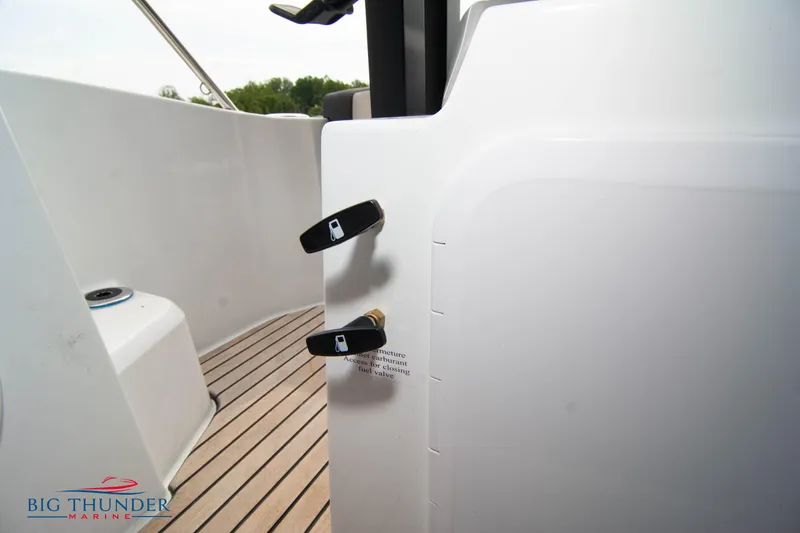 Slide: The Image of 2024 Jeanneau Leader 9.0 WA boat deck with teak flooring and control levers. - 41