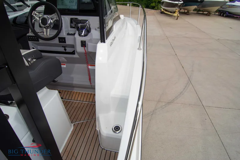 Slide: The Image of 2024 Jeanneau Leader 9.0 WA boat interior with steering wheel and deck view. - 45