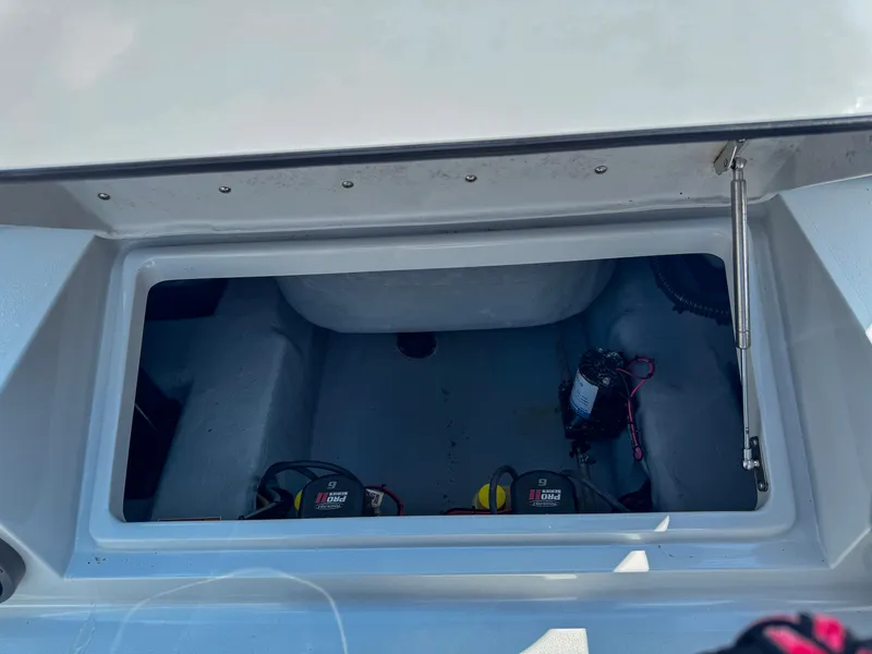 Slide: The Image of Open storage compartment in 2022 Vtech 18Flats boat, showing interior and equipment. - 11