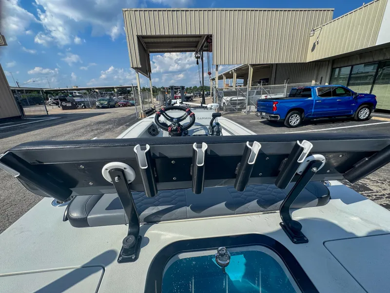 Slide: The Image of Vtech 18Flats 2022 boat with rod holders, steering wheel, and blue truck in background. - 12