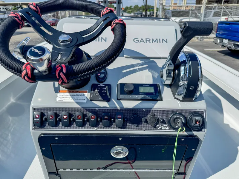 Slide: The Image of Vtech 18Flats 2022 boat dashboard with steering wheel and controls, featuring Garmin technology. - 13