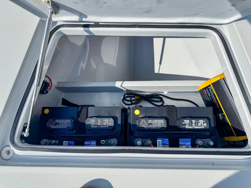 Slide: The Image of Vtech 18Flats 2022 boat battery compartment with two batteries and cables. - 18