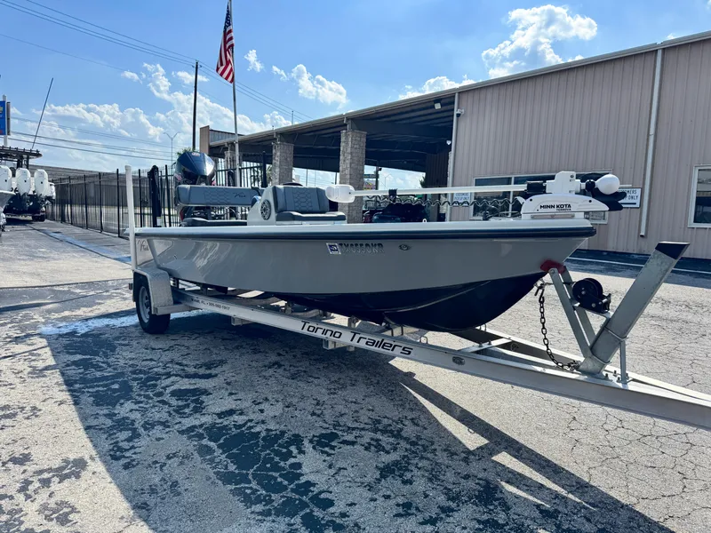 Slide: The Image of Vtech 18Flats 2022 boat on trailer outside industrial building under blue sky. - 4