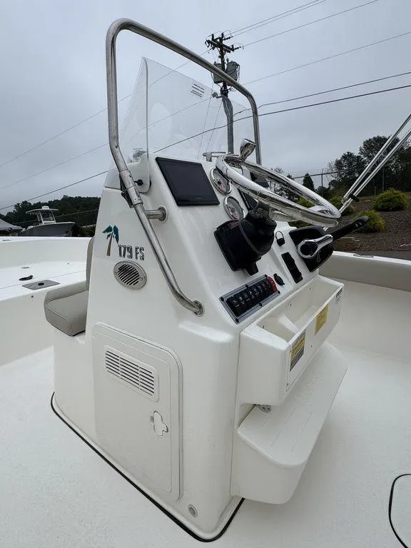 Slide: The Image of 2025 Key West 179 FS boat console with steering wheel and controls. - 12