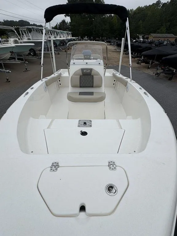 Slide: The Image of 2025 Key West 179 FS boat, white interior, docked with other boats in the background. - 15