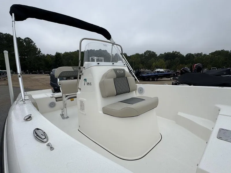 Slide: The Image of 2025 Key West 179 FS boat with seating, parked outdoors. - 17
