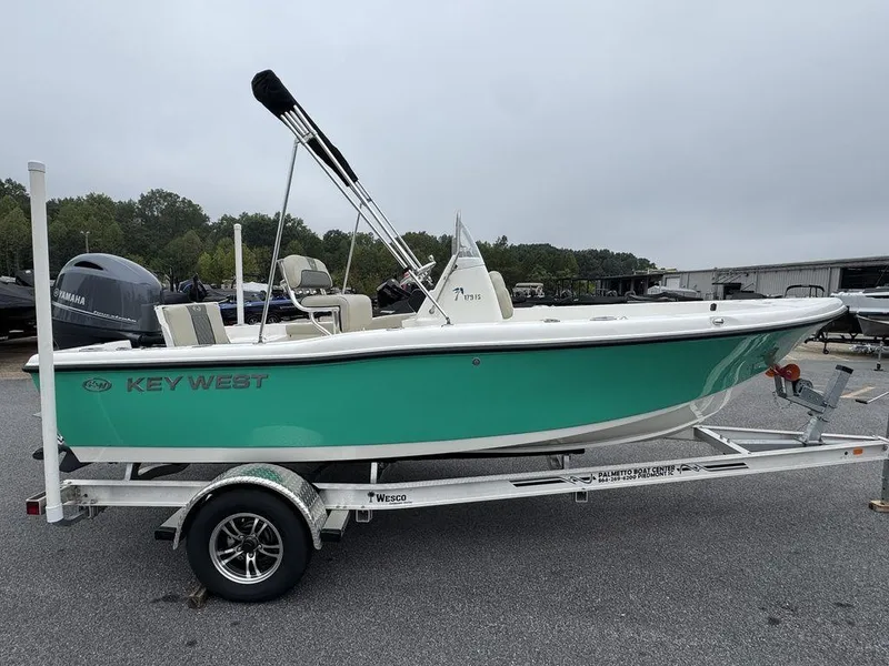 Slide: The Image of 2025 Key West 179 FS boat on trailer, green hull, parked outdoors. - 4