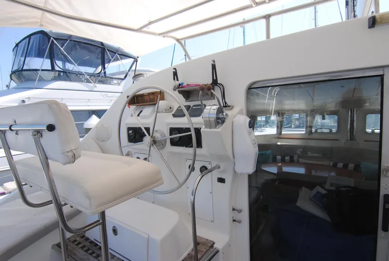 Slide: The Image of Lagoon 410 catamaran cockpit, 1999 model, featuring steering wheel and seating area. - 10