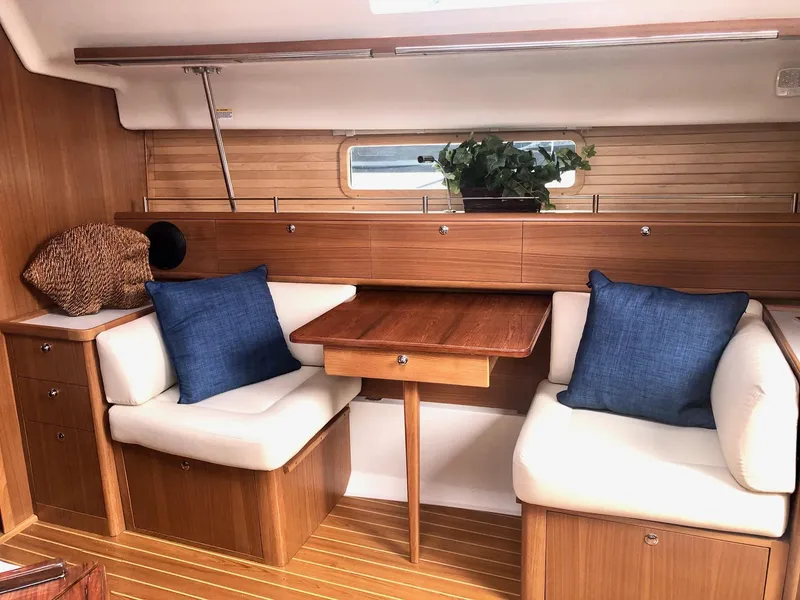 Slide: The Image of Interior of 2023 Catalina 425 yacht with wooden furnishings and blue cushions. - 13