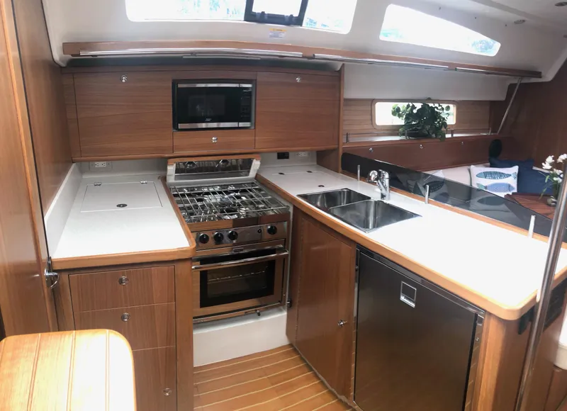 Slide: The Image of Modern kitchen interior of 2023 Catalina 425 yacht with wood finish and stainless appliances. - 17