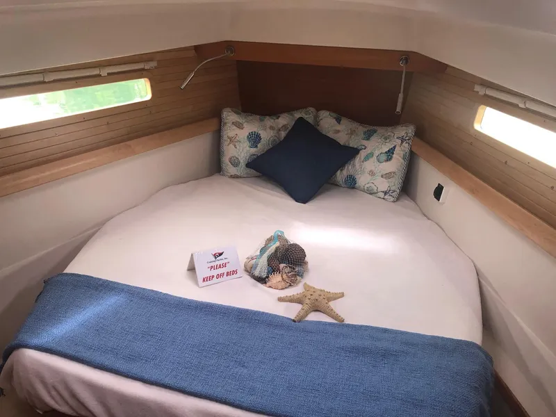 Slide: The Image of Cozy cabin interior of 2023 Catalina 425 sailboat with bed and decorative pillows. - 19