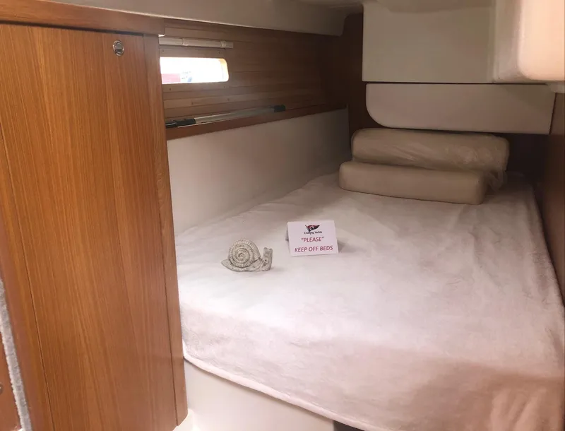 Slide: The Image of Cozy cabin interior of 2023 Catalina 425 sailboat with neatly arranged bedding. - 21