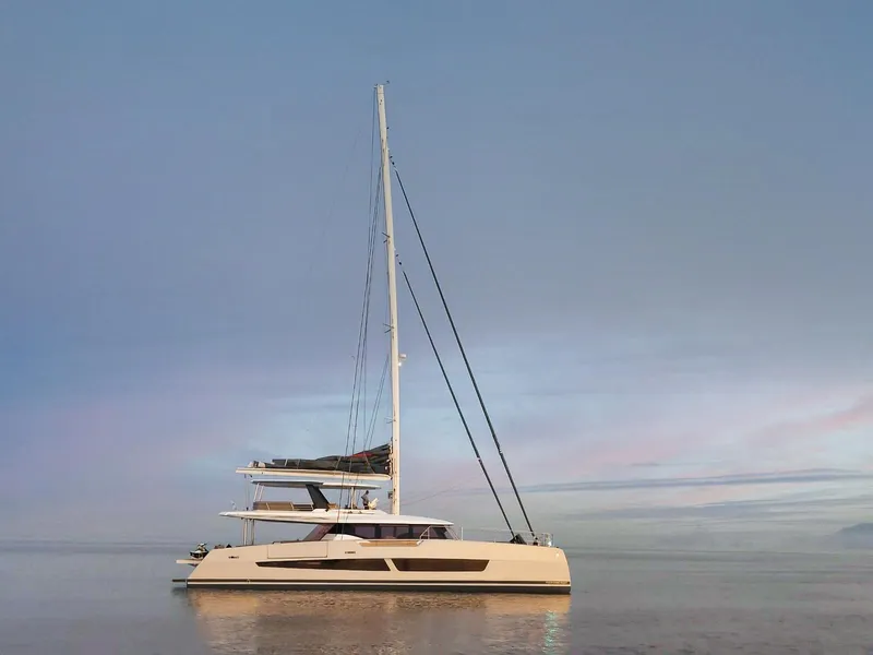 Slide: The Image of Fountaine Pajot Thira 80 catamaran, 2025 model, sailing on calm waters at sunset. - 1