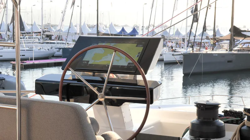 Slide: The Image of Helm of 2025 Fountaine Pajot Thira 80 yacht with navigation display at marina. - 2